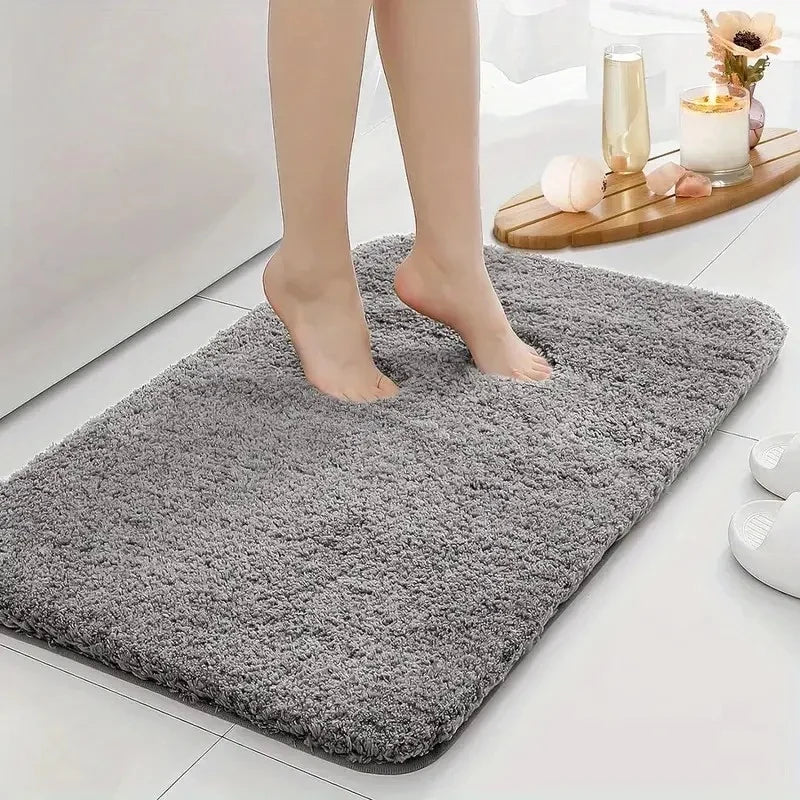 Non-slip thickened bathroom mat designed for water absorption, featuring a soft texture and durable construction for enhanced comfort and safety. 1