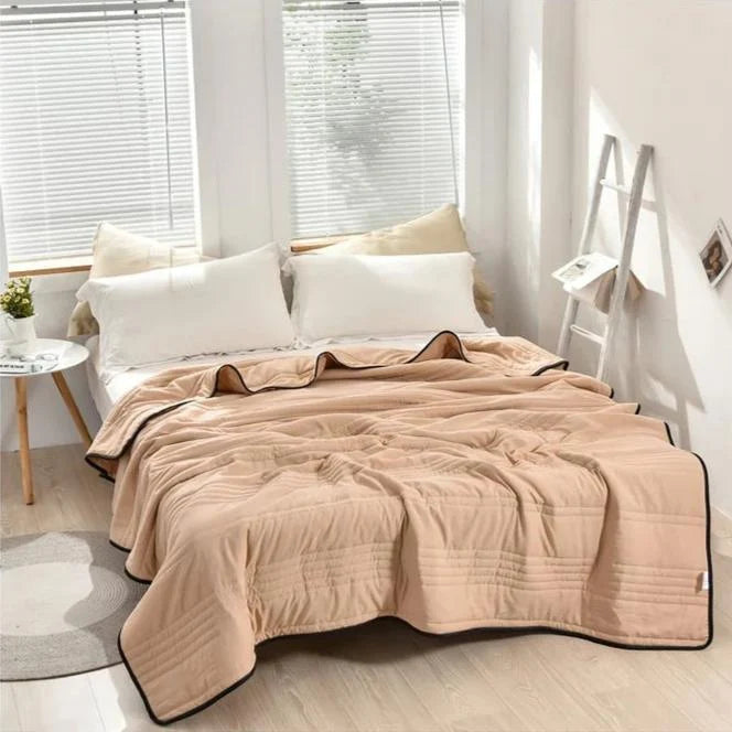 Cooling sleep blanket designed for comfort and breathability, featuring moisture-wicking fabric and a lightweight design for a restful night's sleep. 9