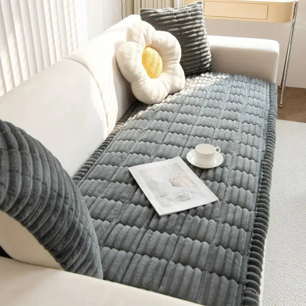 Plush flannel anti-slip sofa cover with pleated edges in a cozy living room setting, providing comfort and style while protecting furniture. 0