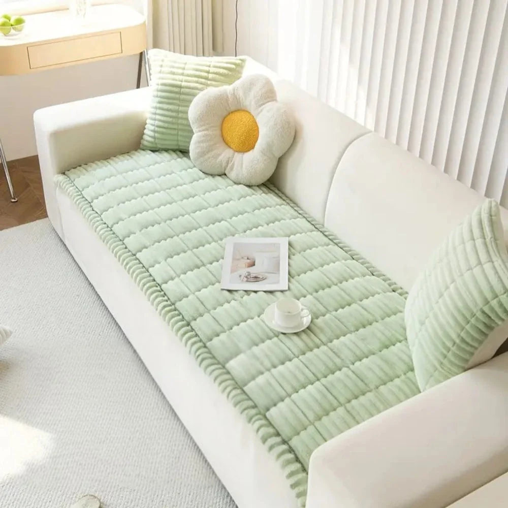 Plush flannel anti-slip sofa cover with pleated edges in a cozy living room setting, providing comfort and style while protecting furniture. 6