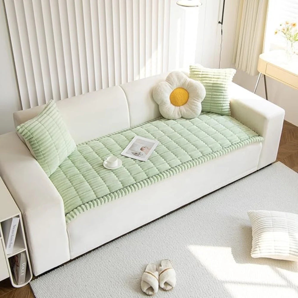 Plush flannel anti-slip sofa cover with pleated edges in a cozy living room setting, providing comfort and style while protecting furniture. 8