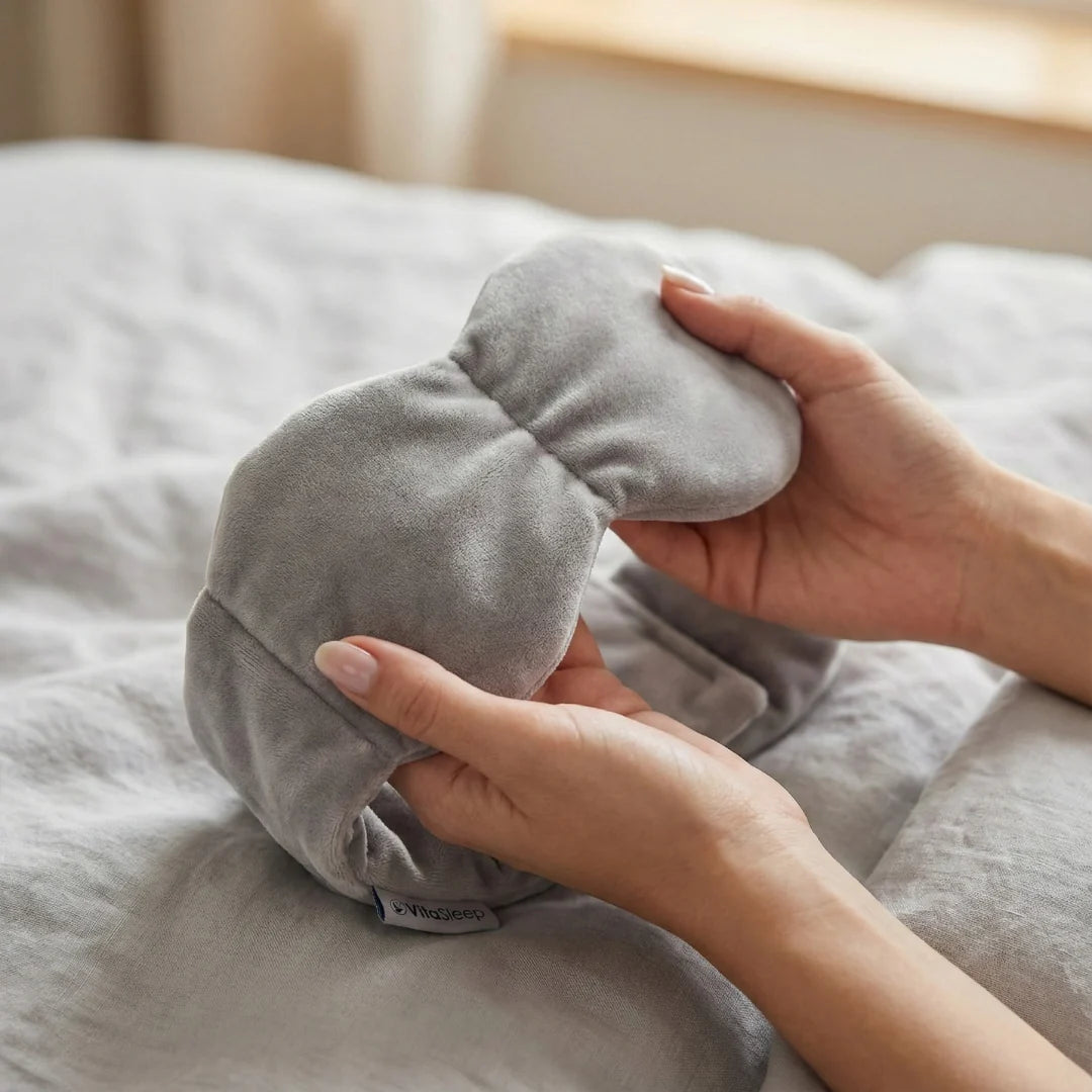 Weighted sleep mask with adjustable strap, featuring a light-blocking design for optimal rest during travel, ideal for sleep and meditation. 1